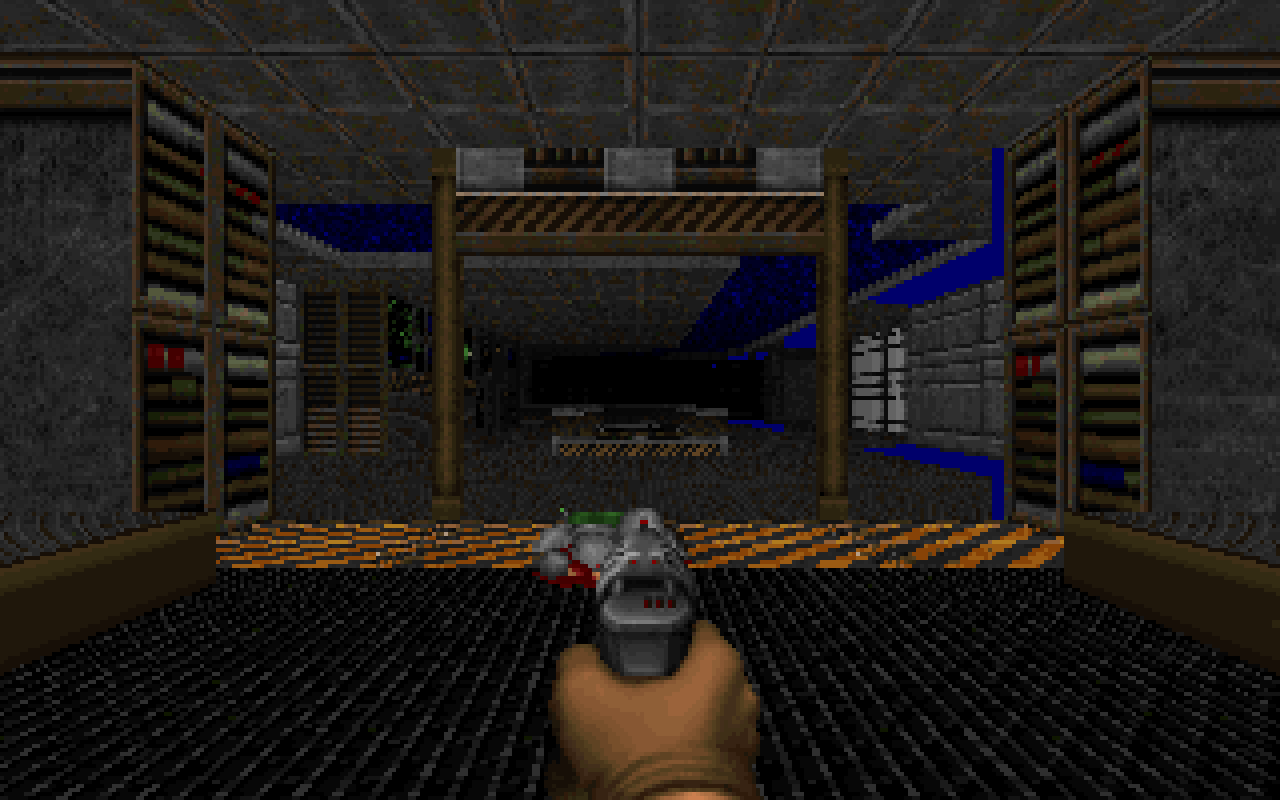 DOOM running full-screen in GLaDOS on FreeDoom's first level, showing textured walls, a lit corridor, a pickup on the floor and the pistol drawn at the bottom of the screen